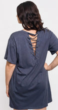 Navy blue dress with lace-up back worn by a person on a white background