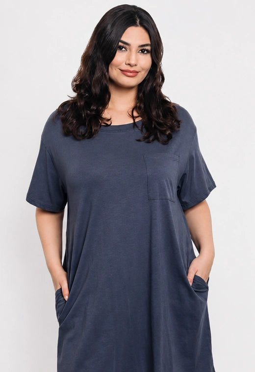 Woman wearing a blue dress with pockets on a white background
